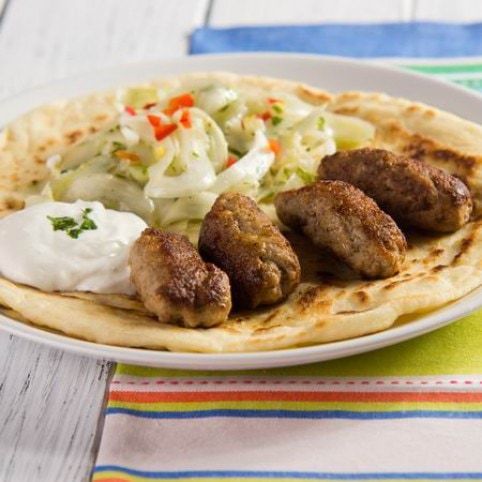 Fűszeres kolbászkák édeskömény-salátával és arab lapos kenyérrel recept