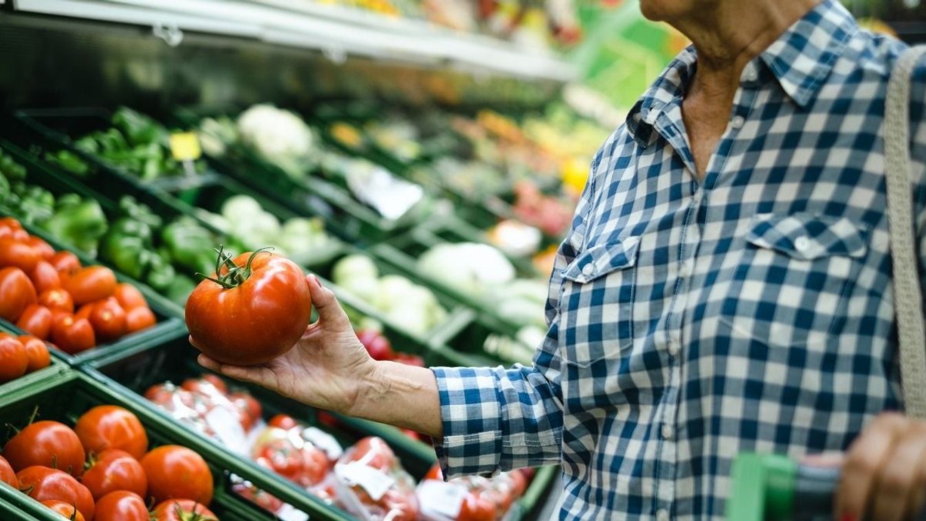 Senior,Woman,At,The,Supermarket,Choosing,Raw,Vegetables,,Holding,In