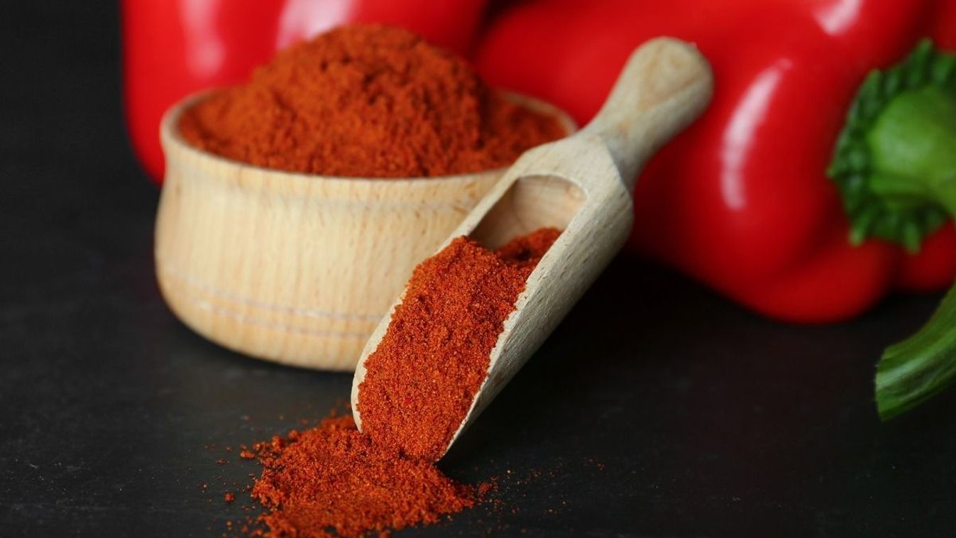 Paprika,Powder,And,Fresh,Bell,Peppers,On,Black,Table,,Closeup