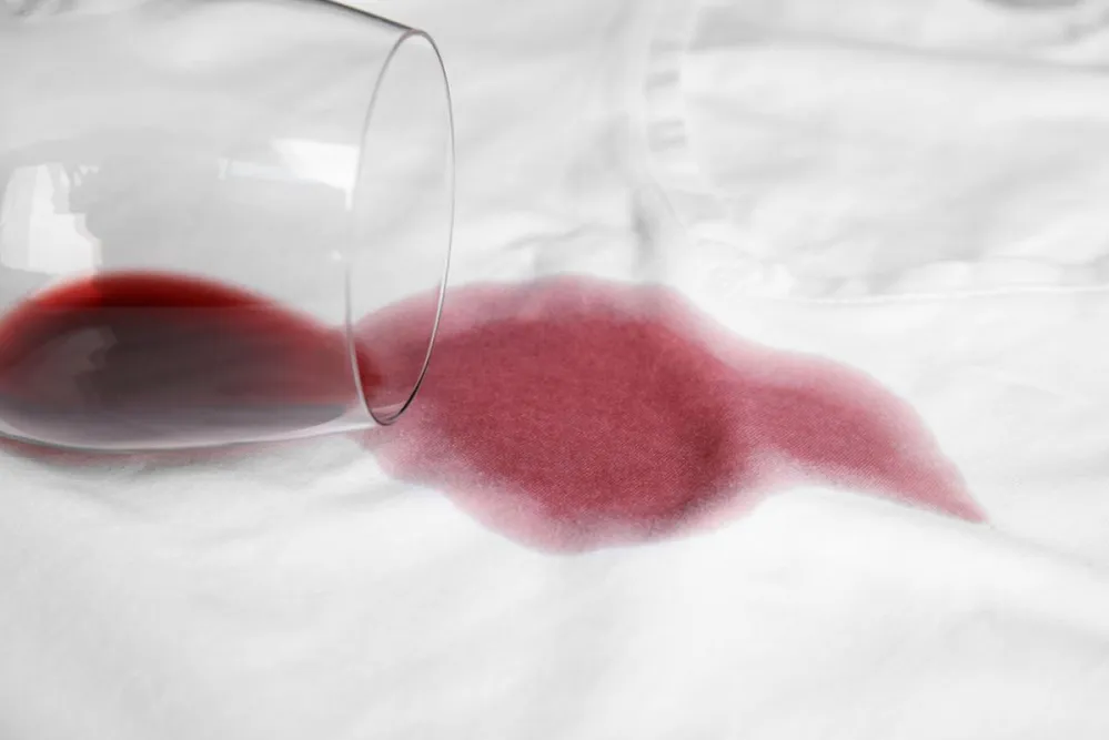 Overturned,Glass,And,Spilled,Exquisite,Red,Wine,On,White,T-shirt. 1542824963