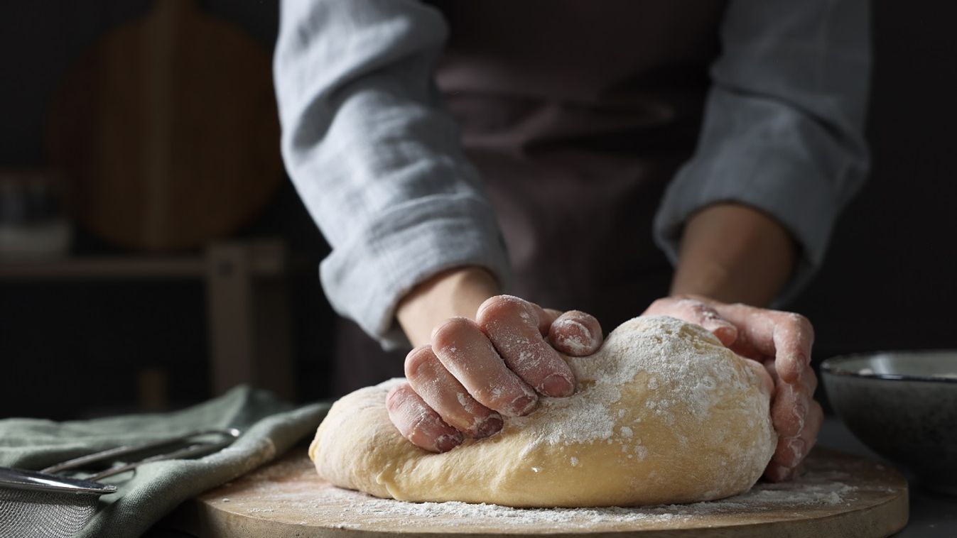 Woman,Kneading,Dough,At,Grey,Table,,Closeup