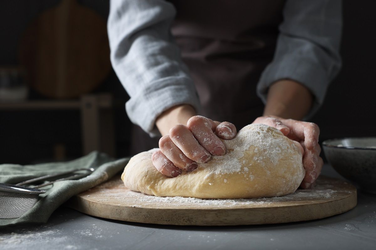 Woman,Kneading,Dough,At,Grey,Table,,Closeup