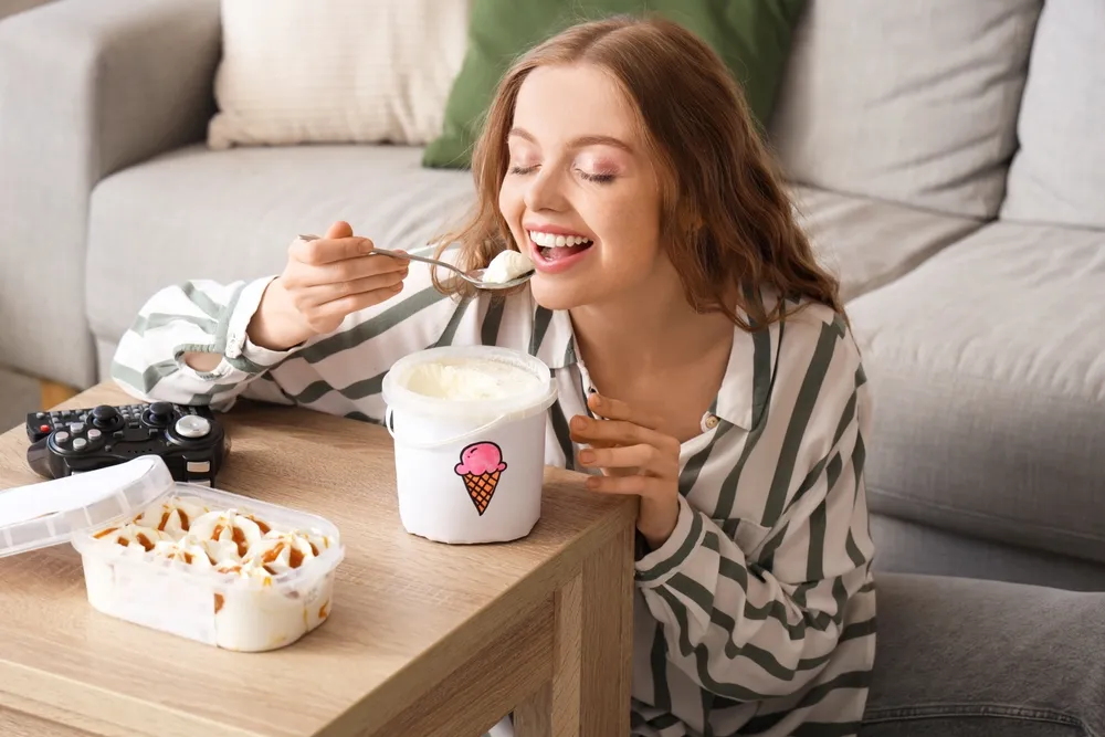 Young,Woman,Eating,Ice,Cream,At,Home